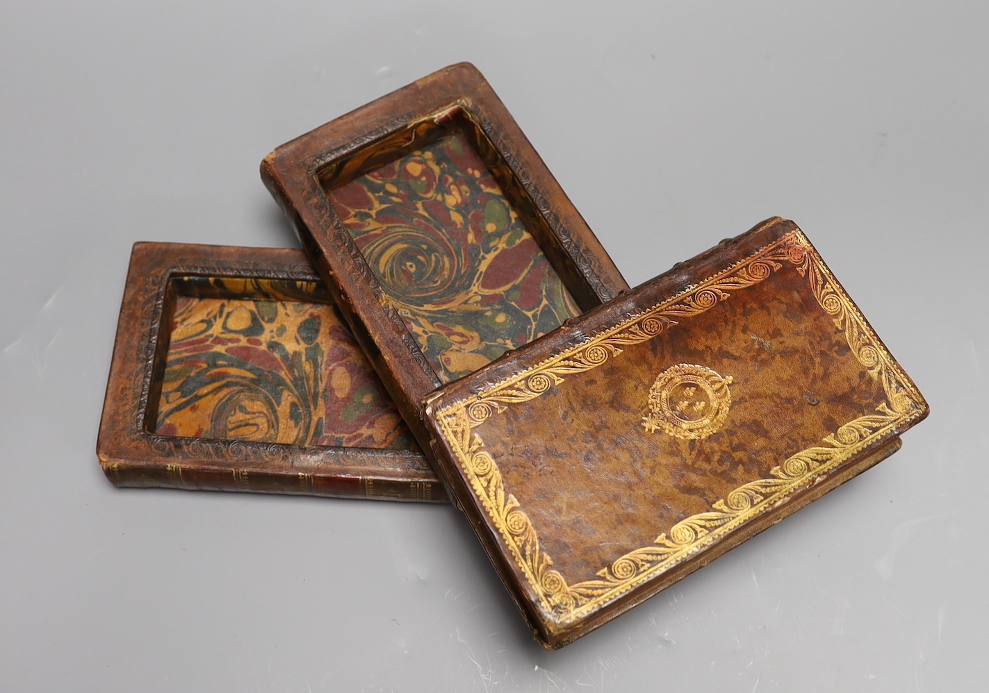 An 18th century leather bound book safe, formed of three leather bound volumes, 9 cms high x 17 wide